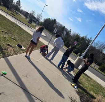 Students jumping and measuring their distances.