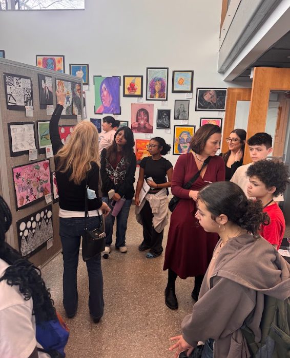 students walking around art displays