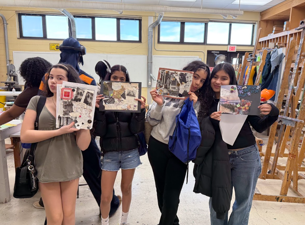 Students holding up their artwork