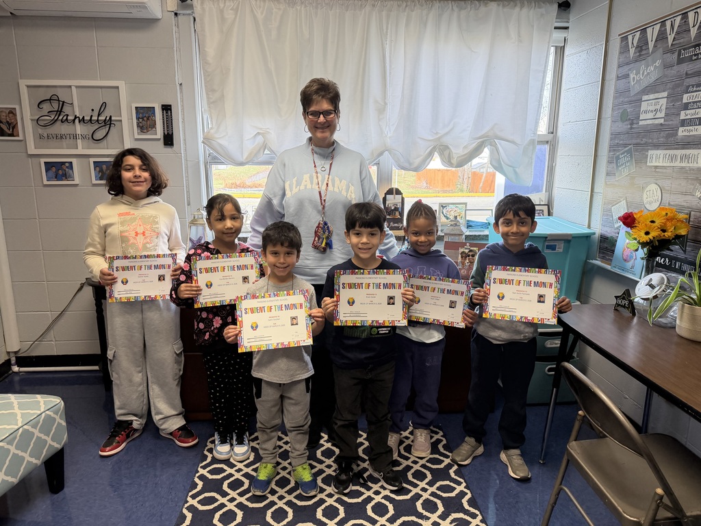 Students holding certificates, standing with their principal