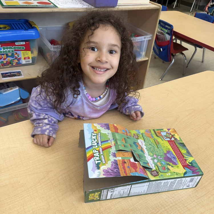 Student posing with Leprechaun Trap Family Project ☘️🌈
