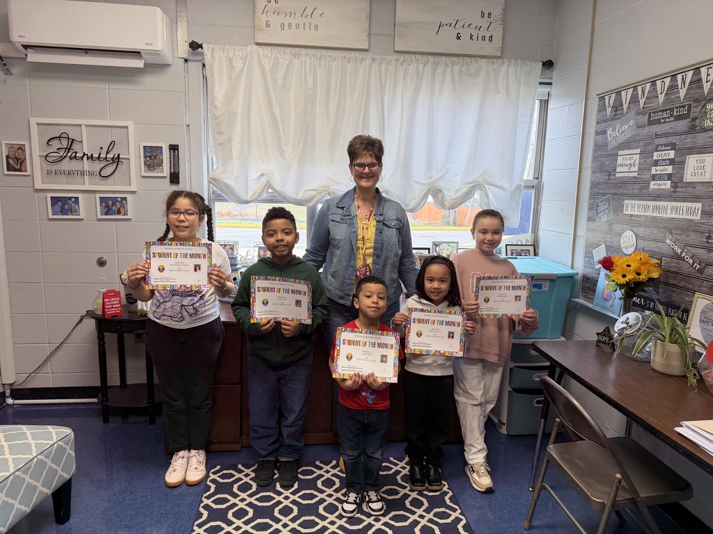 Group of students standing with certificates with the principal