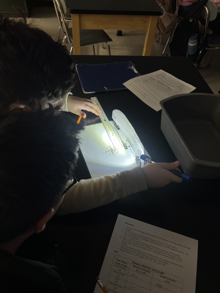 Student using flashlights for a Shadow investigation