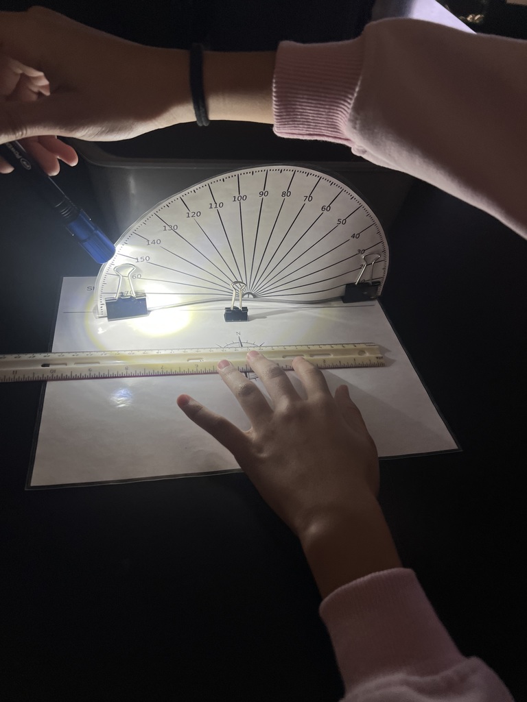 Student using flashlights for a Shadow investigation