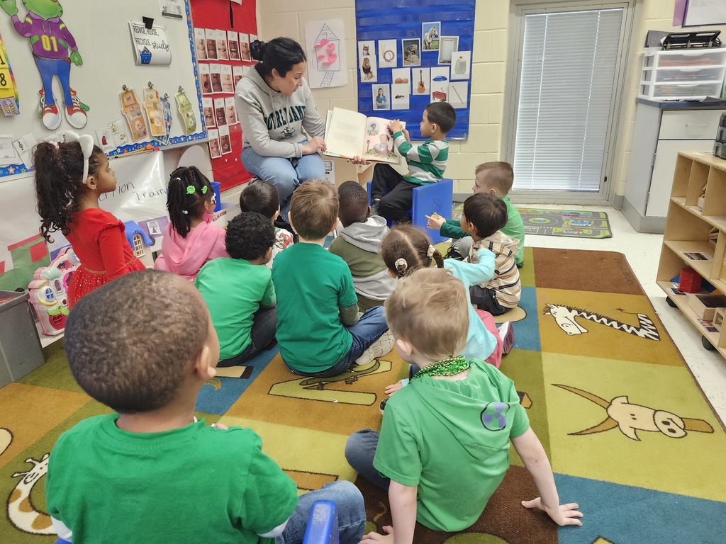 Mystery Readers Story time. Parent standing with group of students