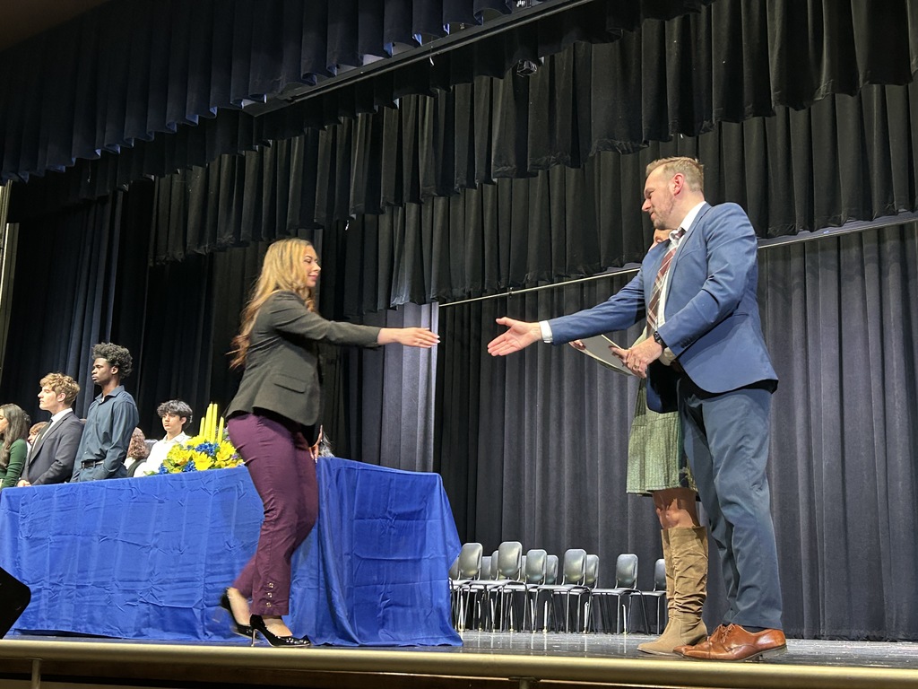Student shaking hands and accepting certificate