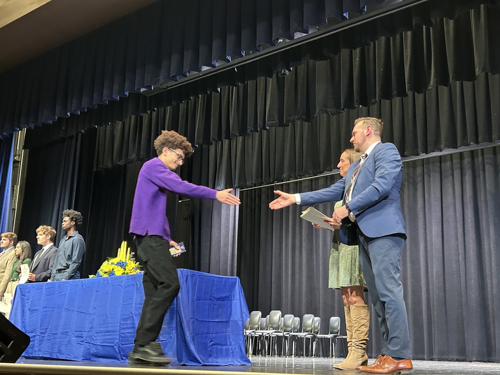 Student shaking hands and accepting certificate
