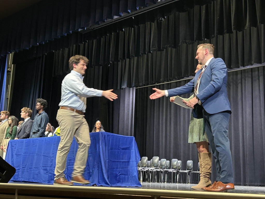 Student shaking hands and accepting certificate