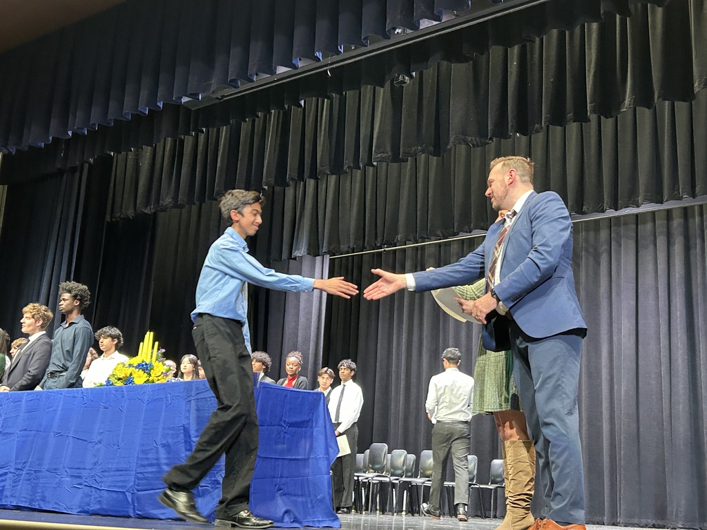 Student shaking hands and accepting certificate