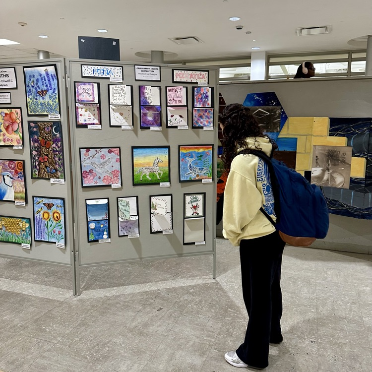Student looking at art