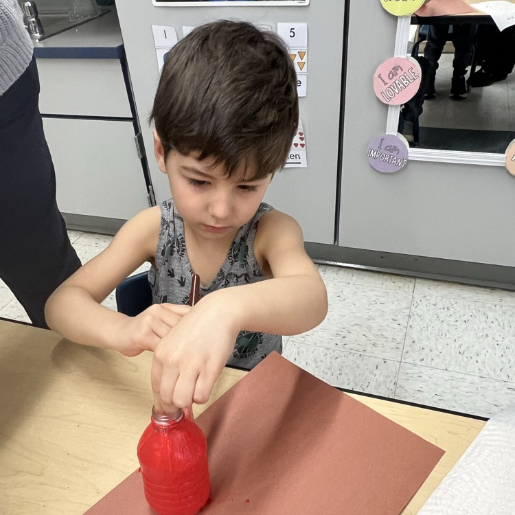 Student working with recyclable items to make projects