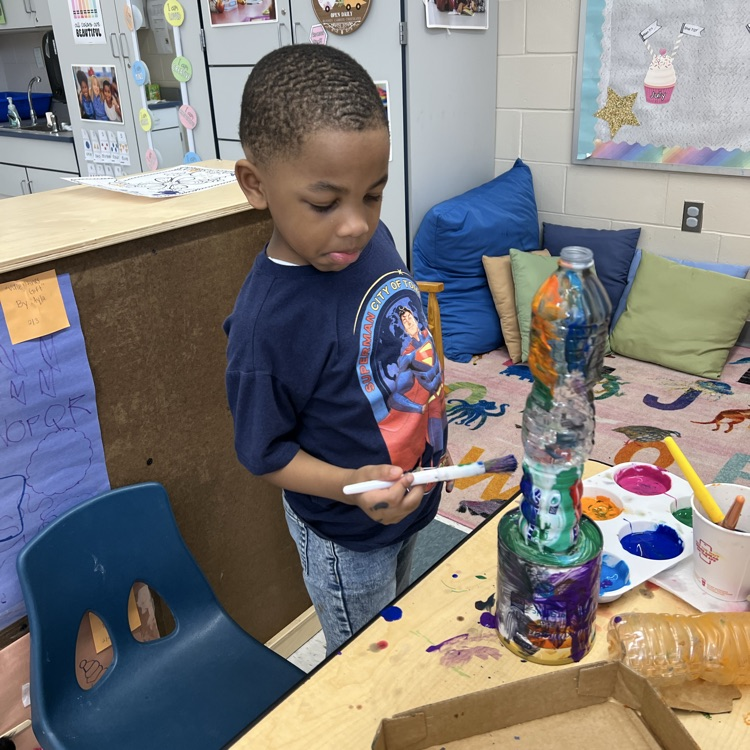 Student working with recyclable items to make projects
