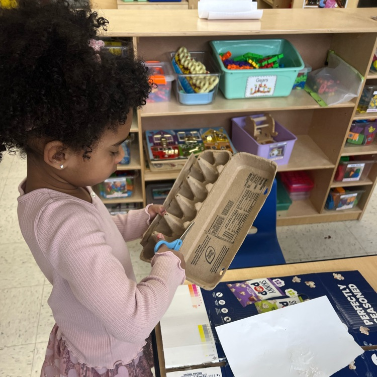 Student working with recyclable items to make projects