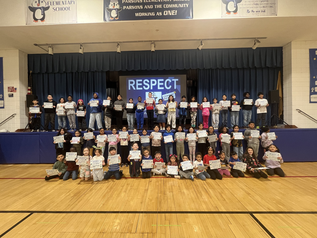 Large group of students posing with certficates in front of the word Respect