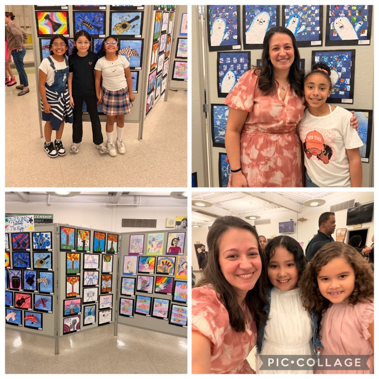 Students posing with their teacher and paintings on display