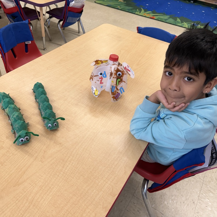Students in a classroom looking at projects