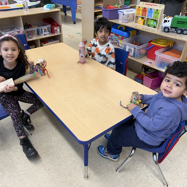 Students in a classroom looking at projects