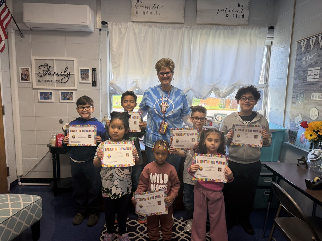 Students posing with certificates with their principal
