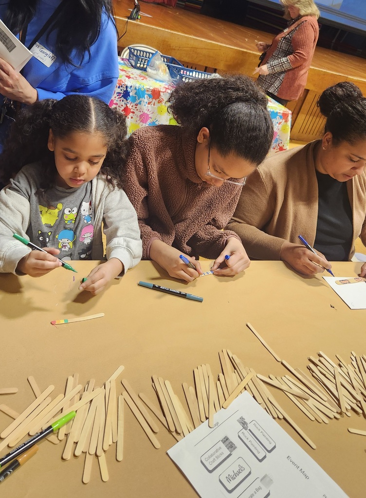 Families decorating popsicle sticks