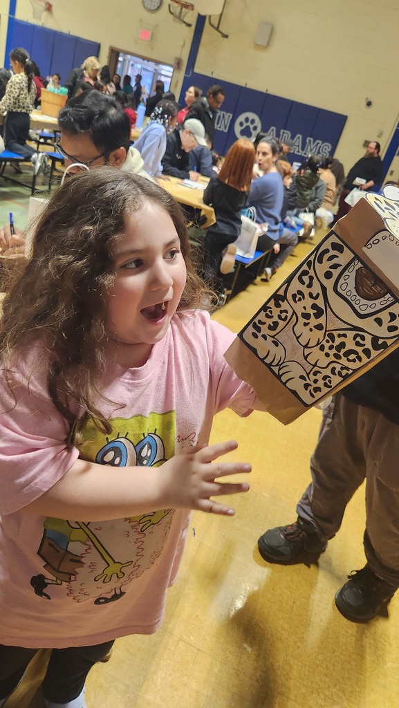 Students smiling at a jaguar art project