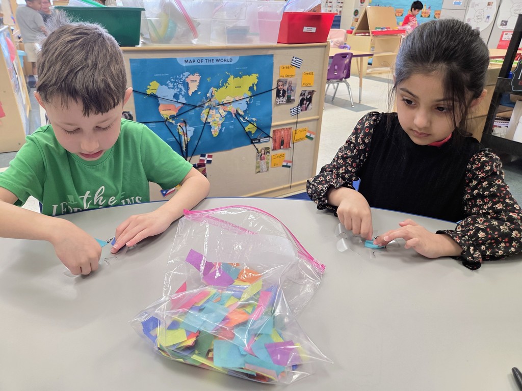 Students making puzzle pieces at a table