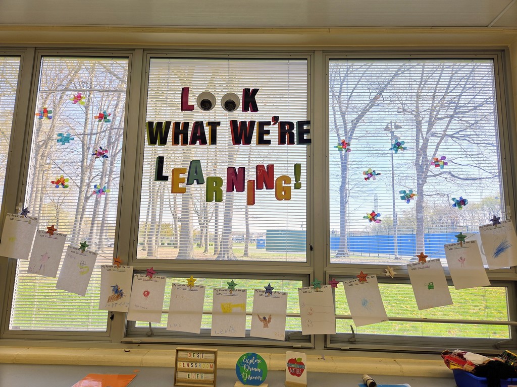 Student work hanging on the classroom windows