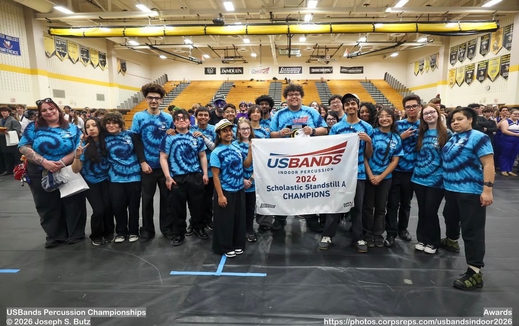 Indoor percussion with their 1st place championship banner 