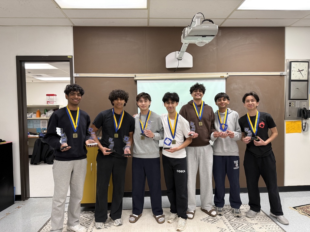 A few of the DECA winners posing with their medals and trophies