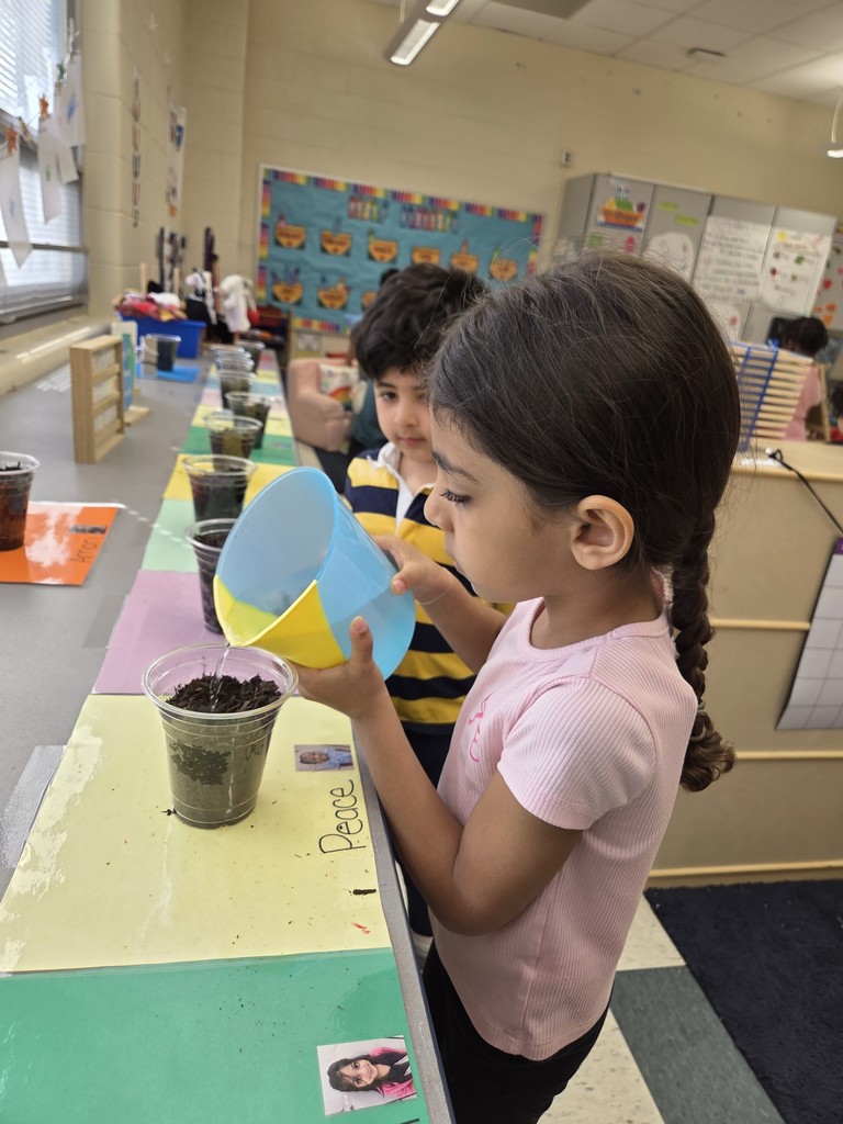 Kids planting flowers in little pots