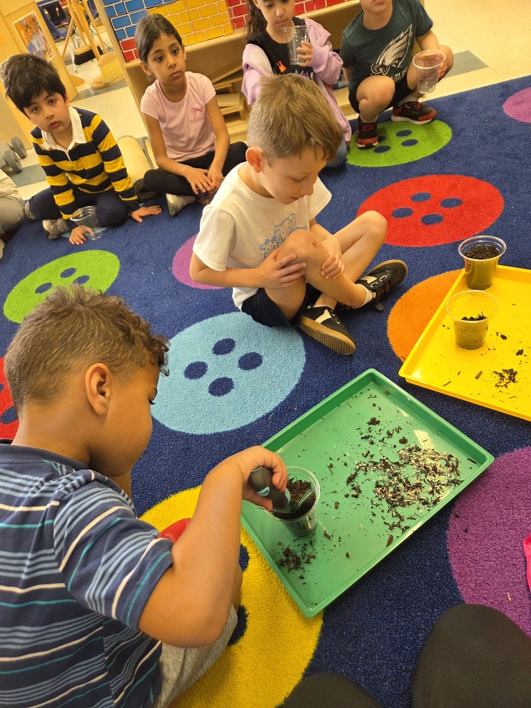 Kids planting flowers in little pots