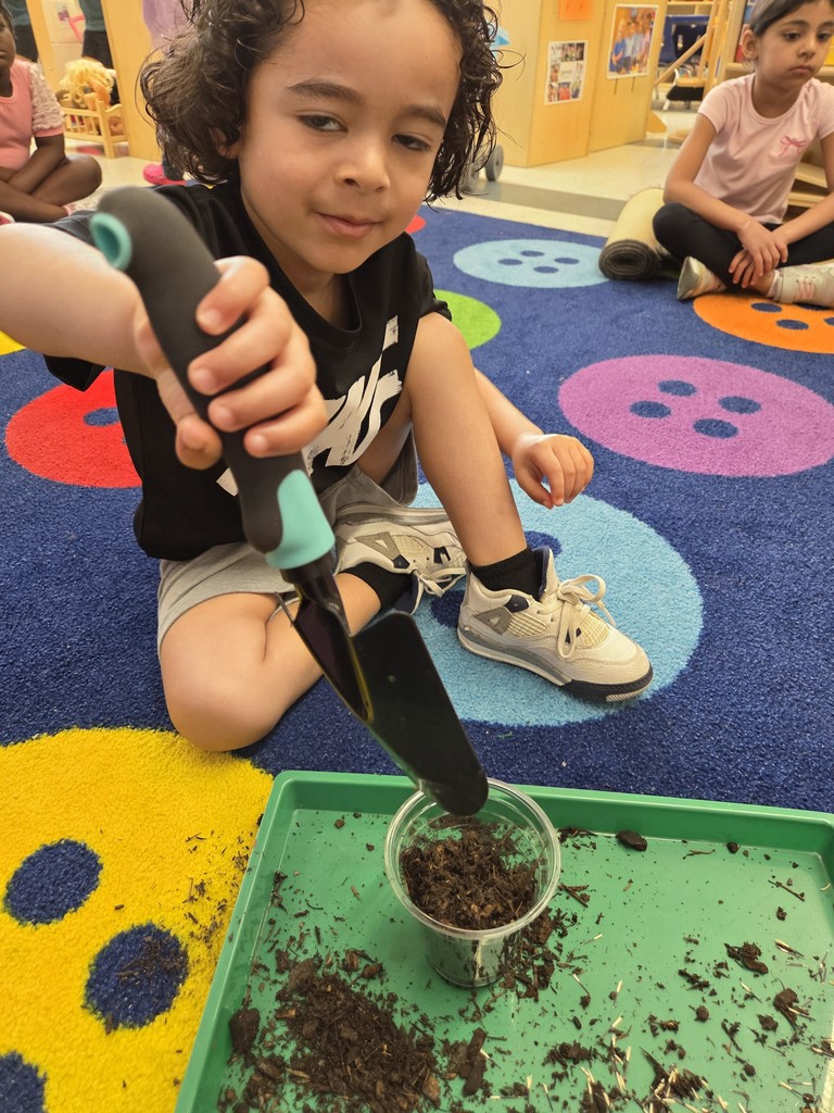 Kids planting flowers in little pots