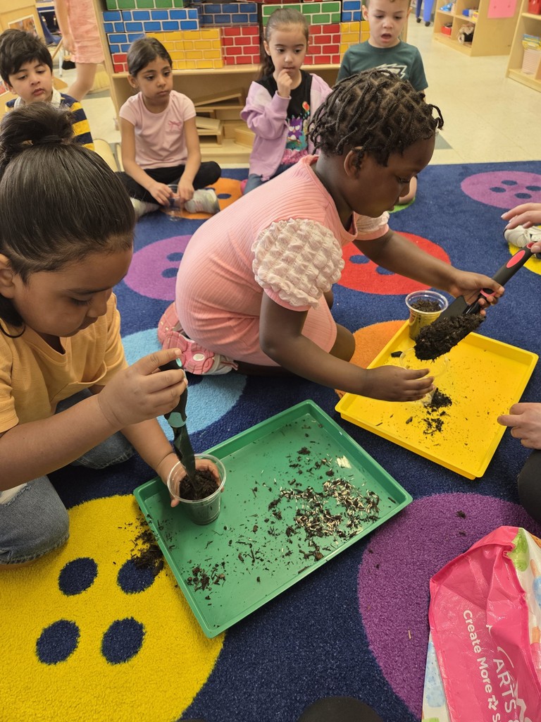 Kids planting flowers in little pots
