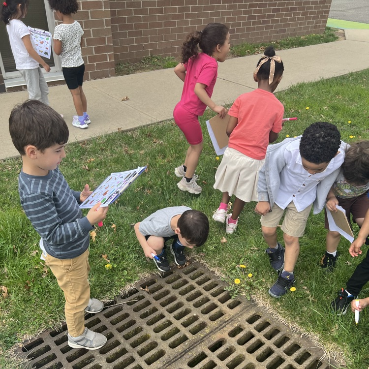 Students marking off a paper scavenge hunt about nature