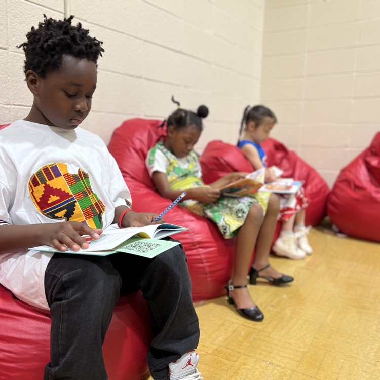 Students reading in beanbag chairs at International Night