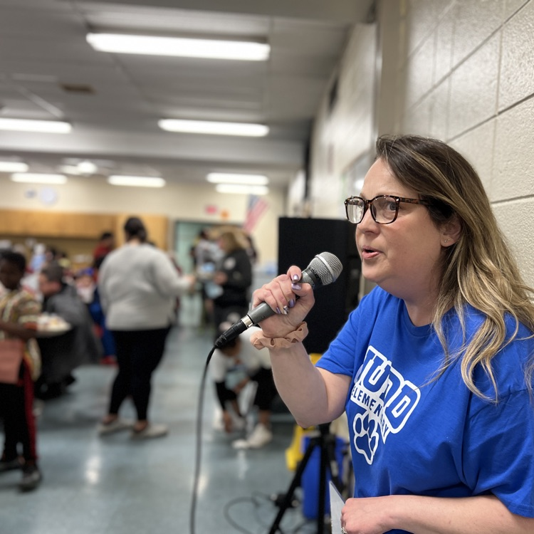 teacher speaking into microphone