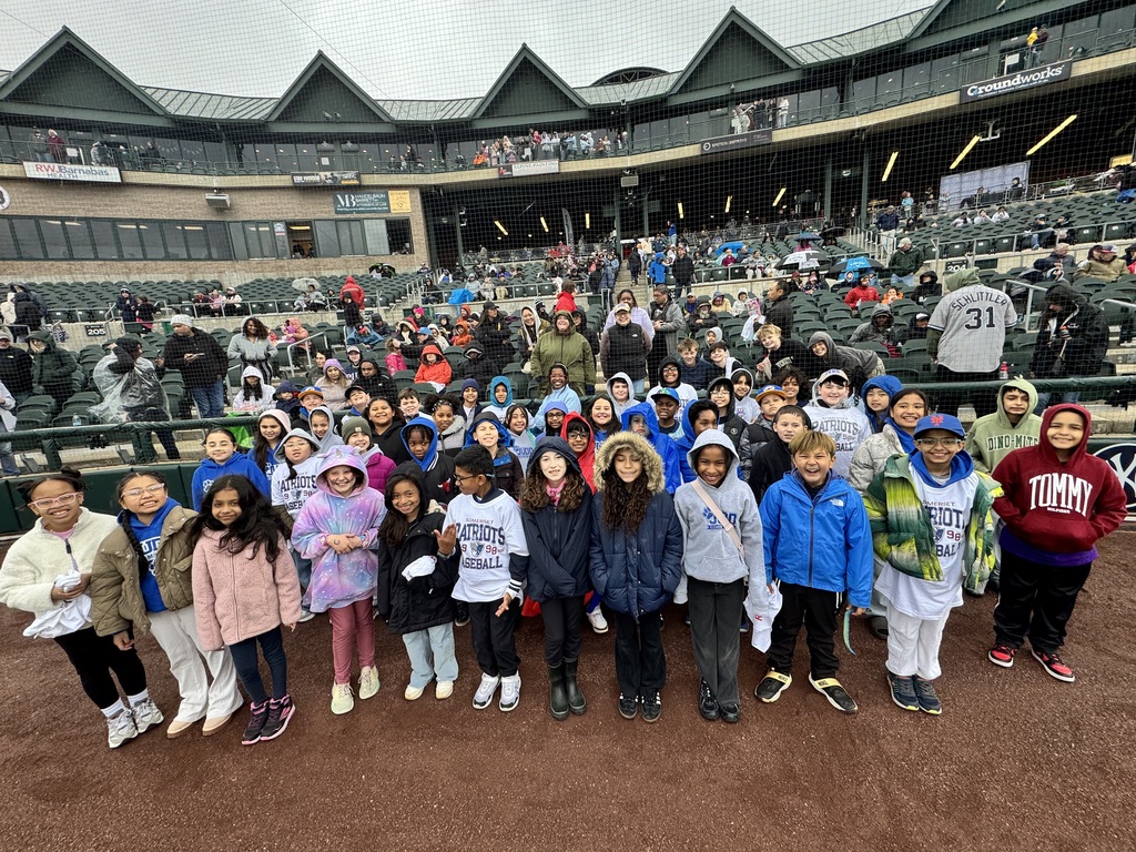 Students standing in the baseball stadium