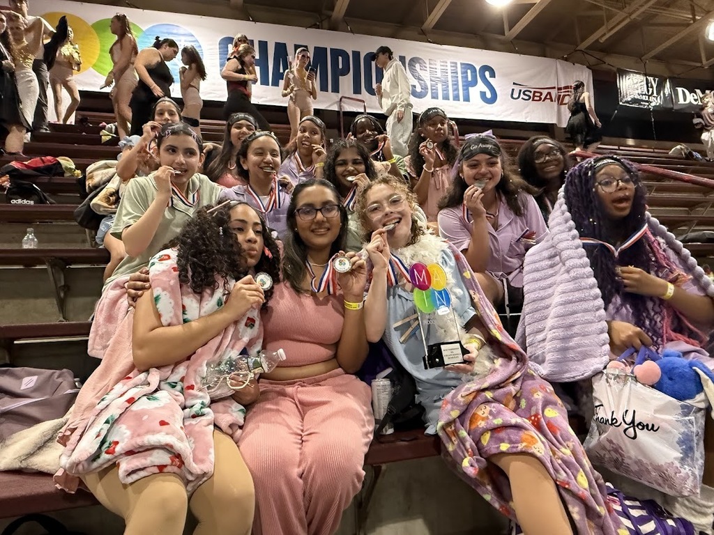 Celebrating their Silver medals by biting their medals 