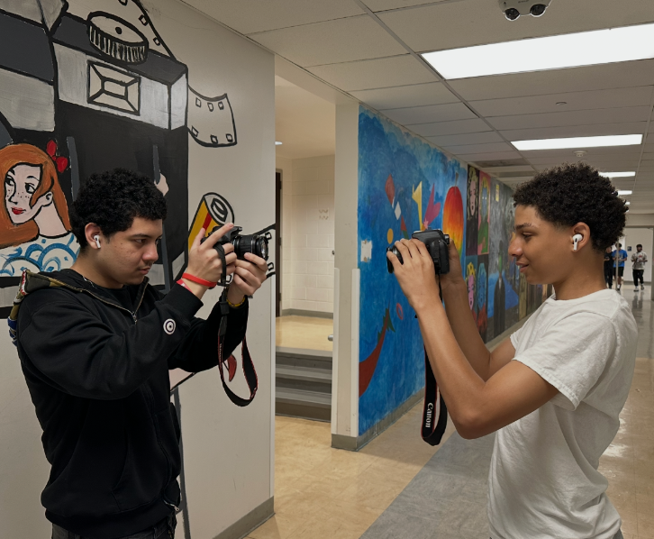 Two students taking photos of one another
