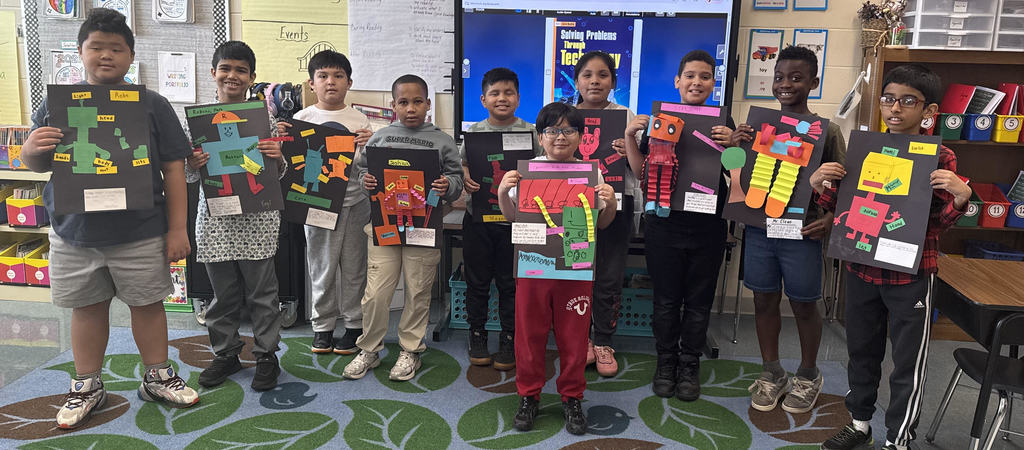 Students showing off robot art work.