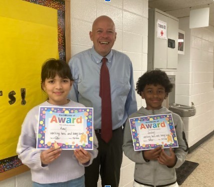 Friday Five 5/1/26, Students standing with principal