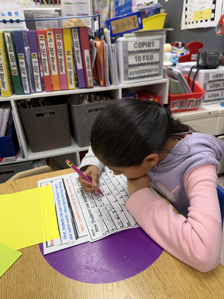 Student working on worksheets at a table