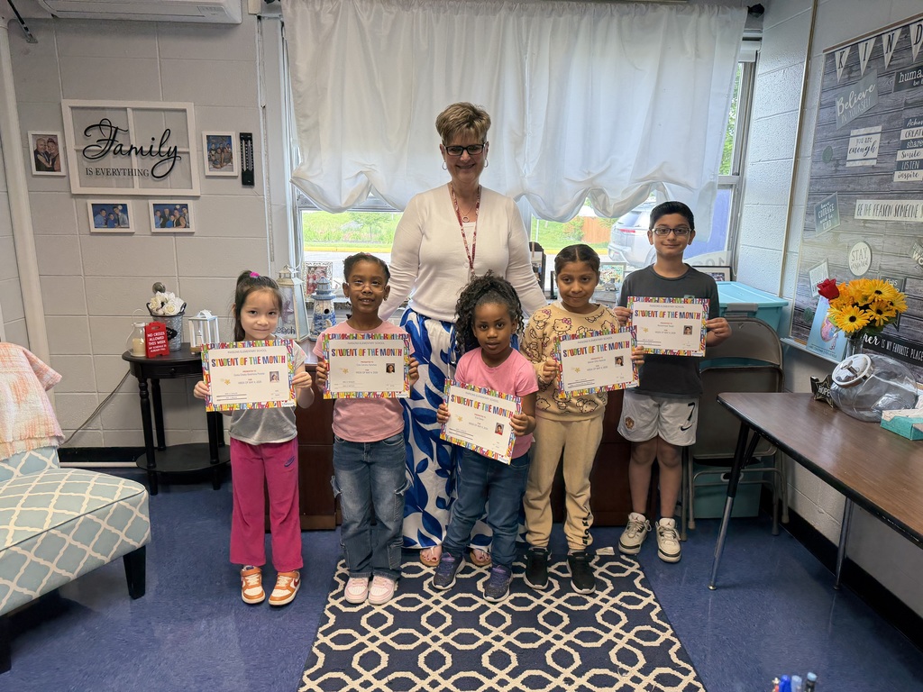 Principal standing with group of students