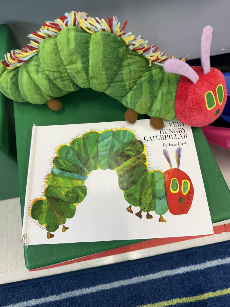 The book The Very Hungry Caterpillar and a large stuffed caterpillar