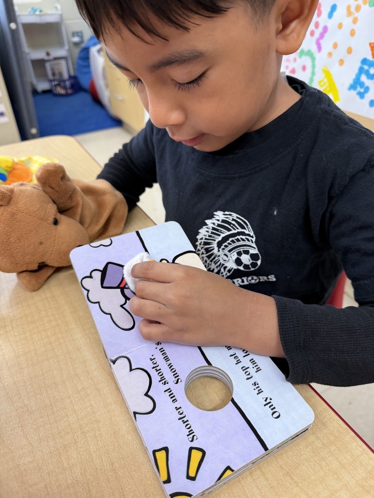 Little puppy enjoyed listening to the book this student was reading.
