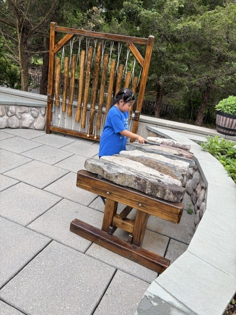 Student at stone marimba