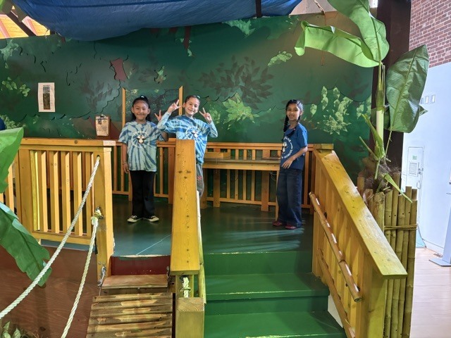 students posing at the top of a stairwell
