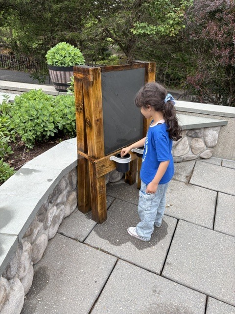 Student at outside chalkboard