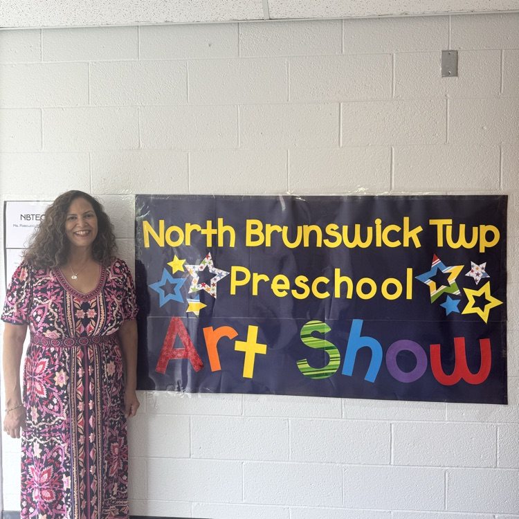 4th Annual Preschool Art Show  banner with teacher standing next to i