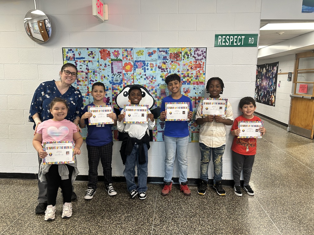 Principal and students standing together with certificates