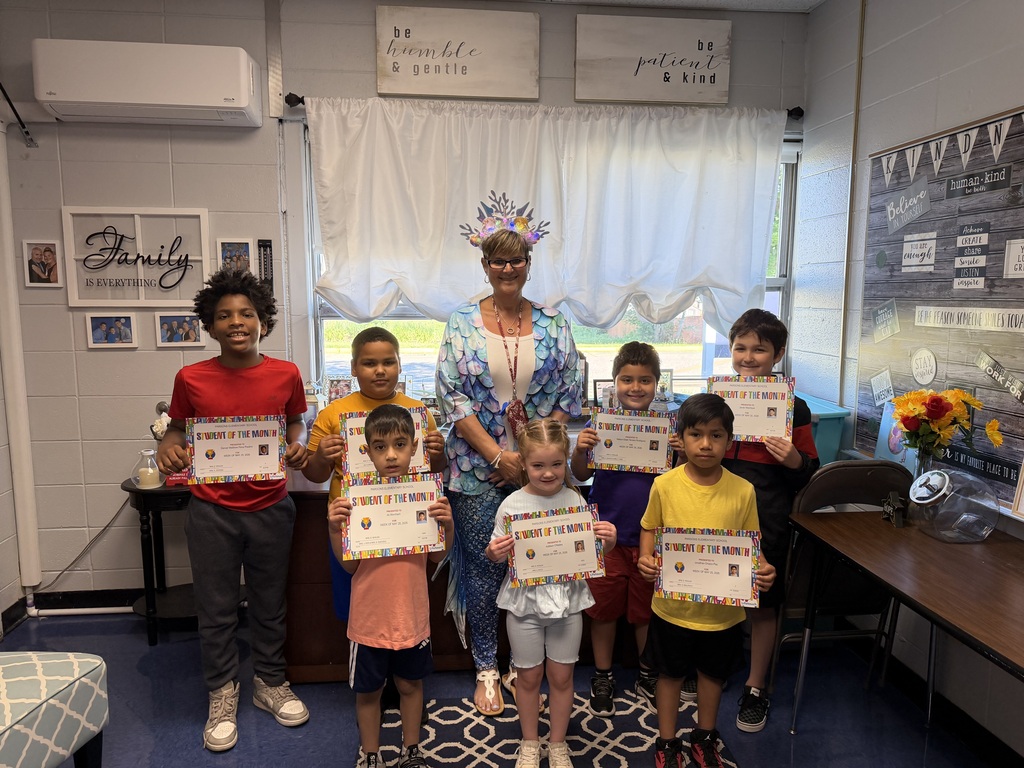 Students standing with principal with certificates
